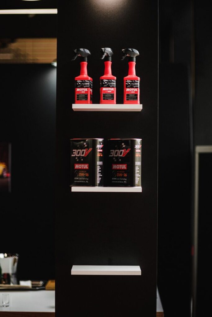 oil-1 Red spray bottles and motor oil containers on a retail display, perfect for automotive-themed content.